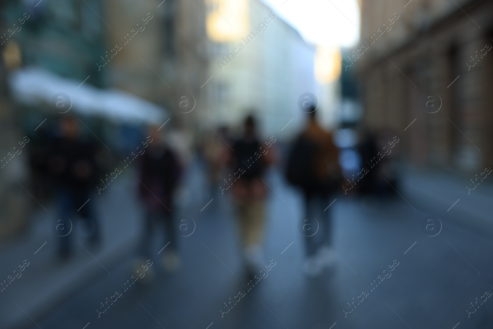 Photo of Blurred view of people walking on city street