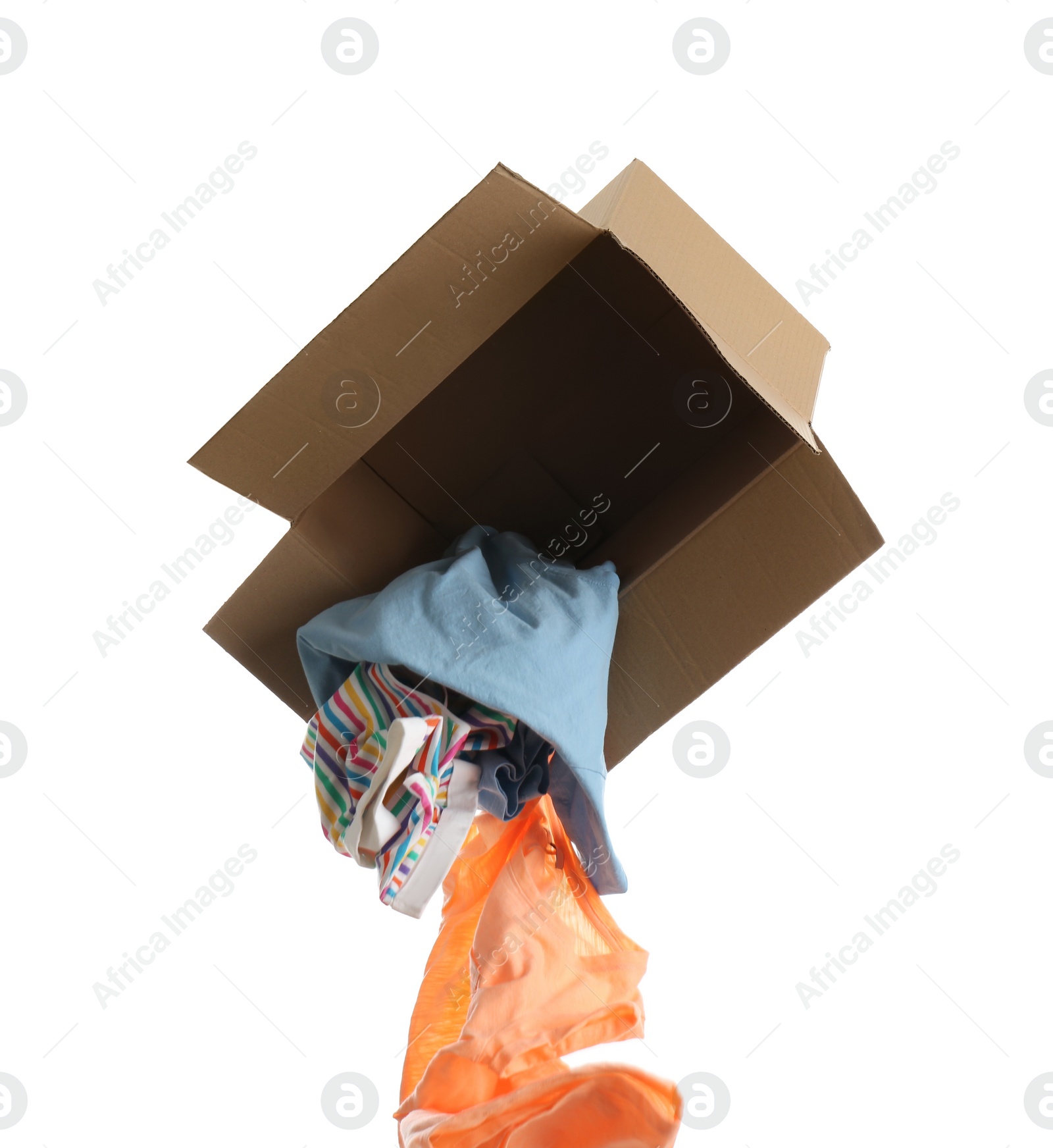 Photo of Overturned cardboard box with clothes isolated on white