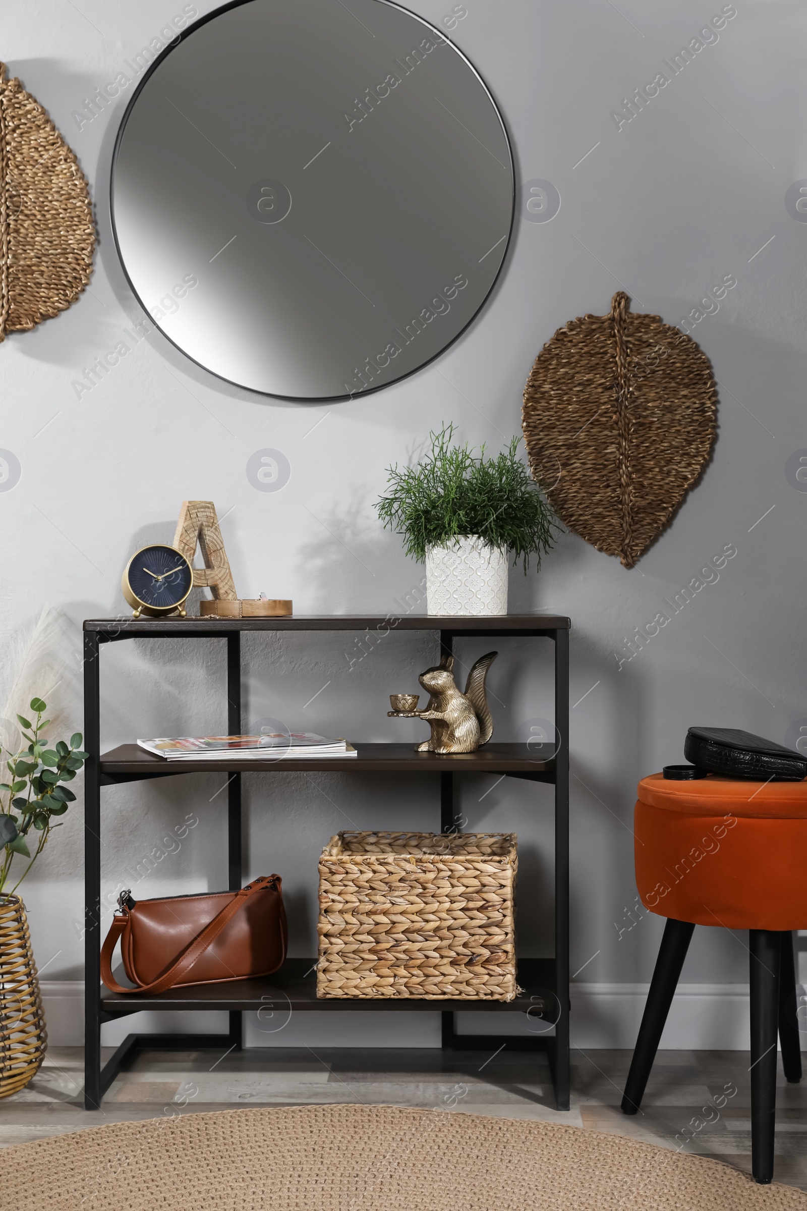 Photo of Stylish room interior with console table and beautiful decor elements