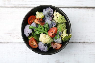 Delicious salad with cauliflower and tomato on white wooden table, top view
