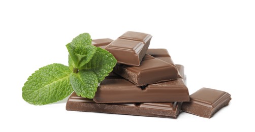 Tasty milk chocolate pieces with mint on white background