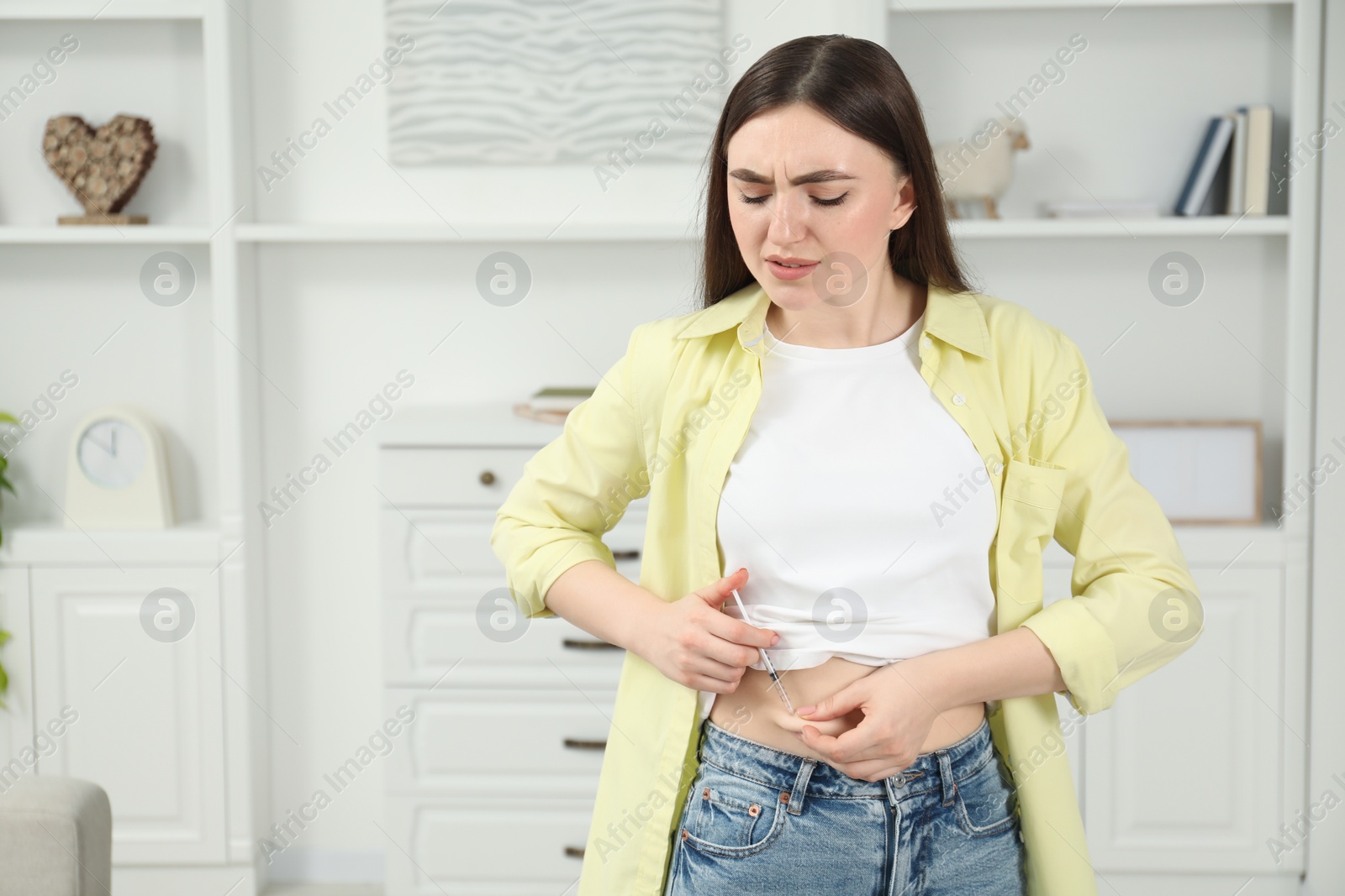 Photo of Diabetes. Woman making insulin injection into her belly at home, space for text