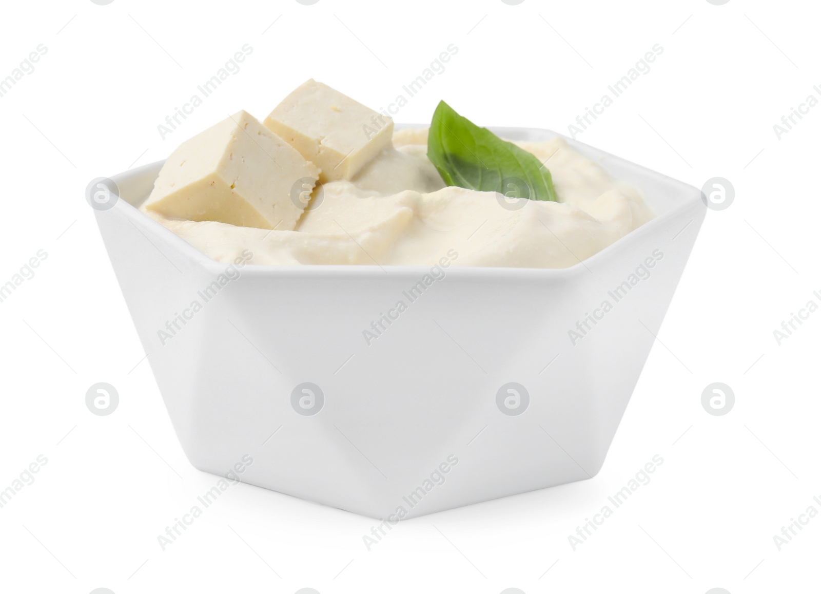 Photo of Delicious tofu sauce and basil leaf in bowl isolated on white