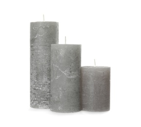 Three color wax candles on white background