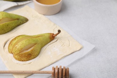 Raw dough with fresh pears on white table, closeup. Space for text