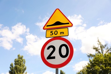 Post with different road signs against sky