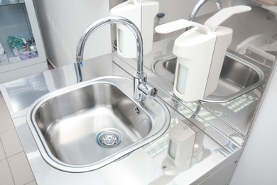 Sterile steel washbasin in modern surgery room