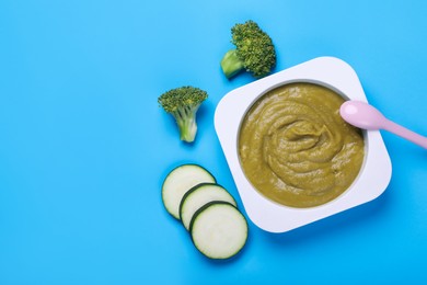 Photo of Healthy baby food and vegetables on light blue background, flat lay. Space for text