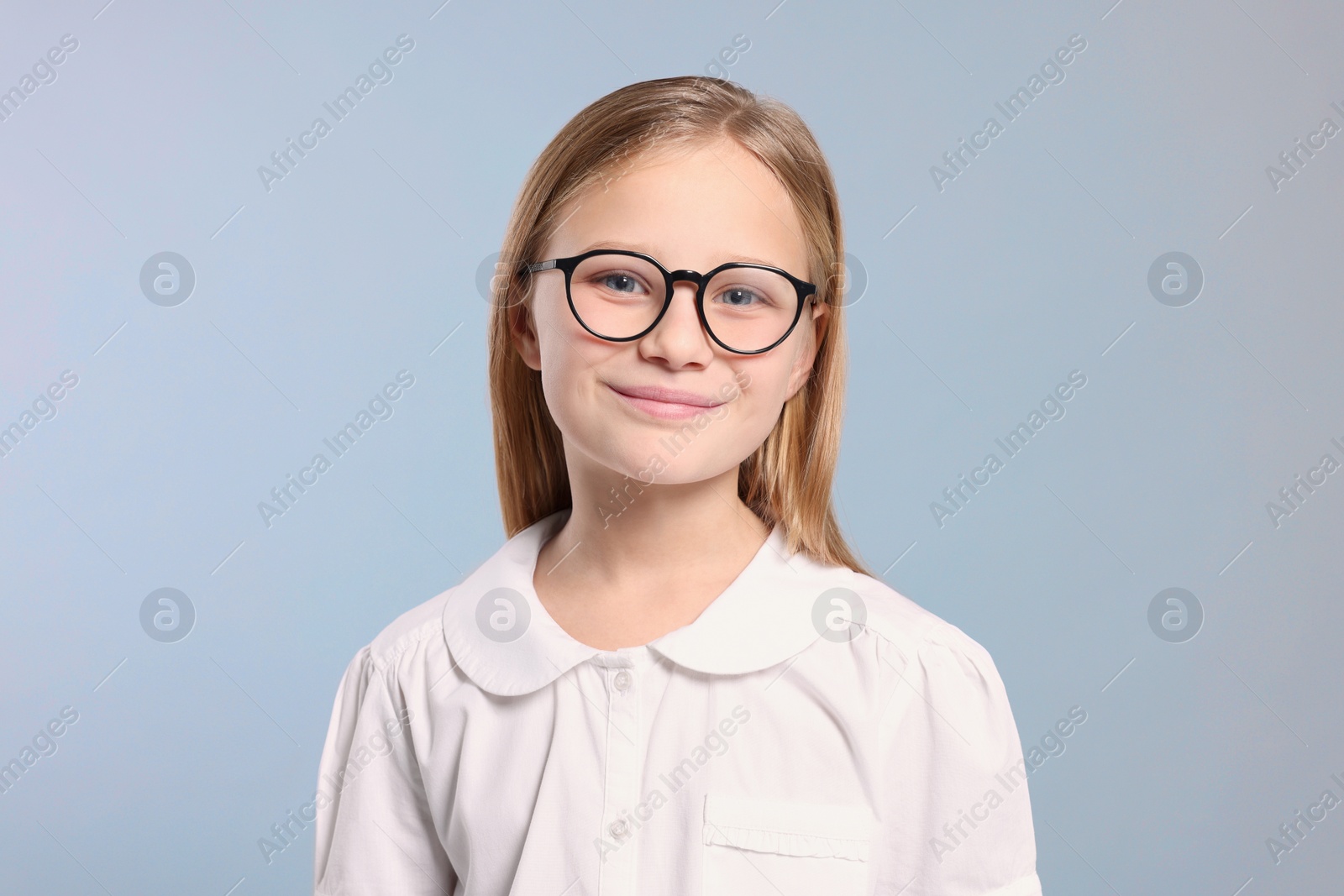 Photo of Portrait of cute girl in glasses on light grey background