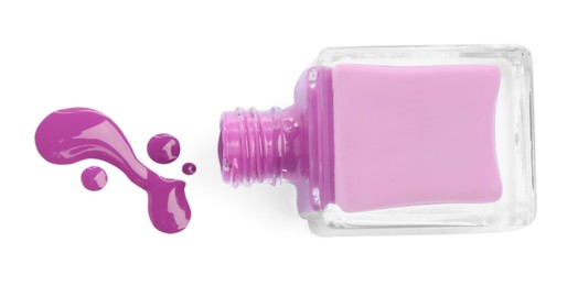 Photo of Bottle and spilled purple nail polish isolated on white, top view