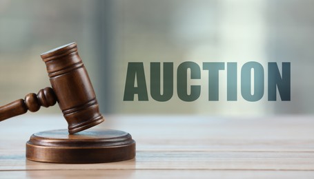 Image of Auction. Gavel on white wooden table indoors