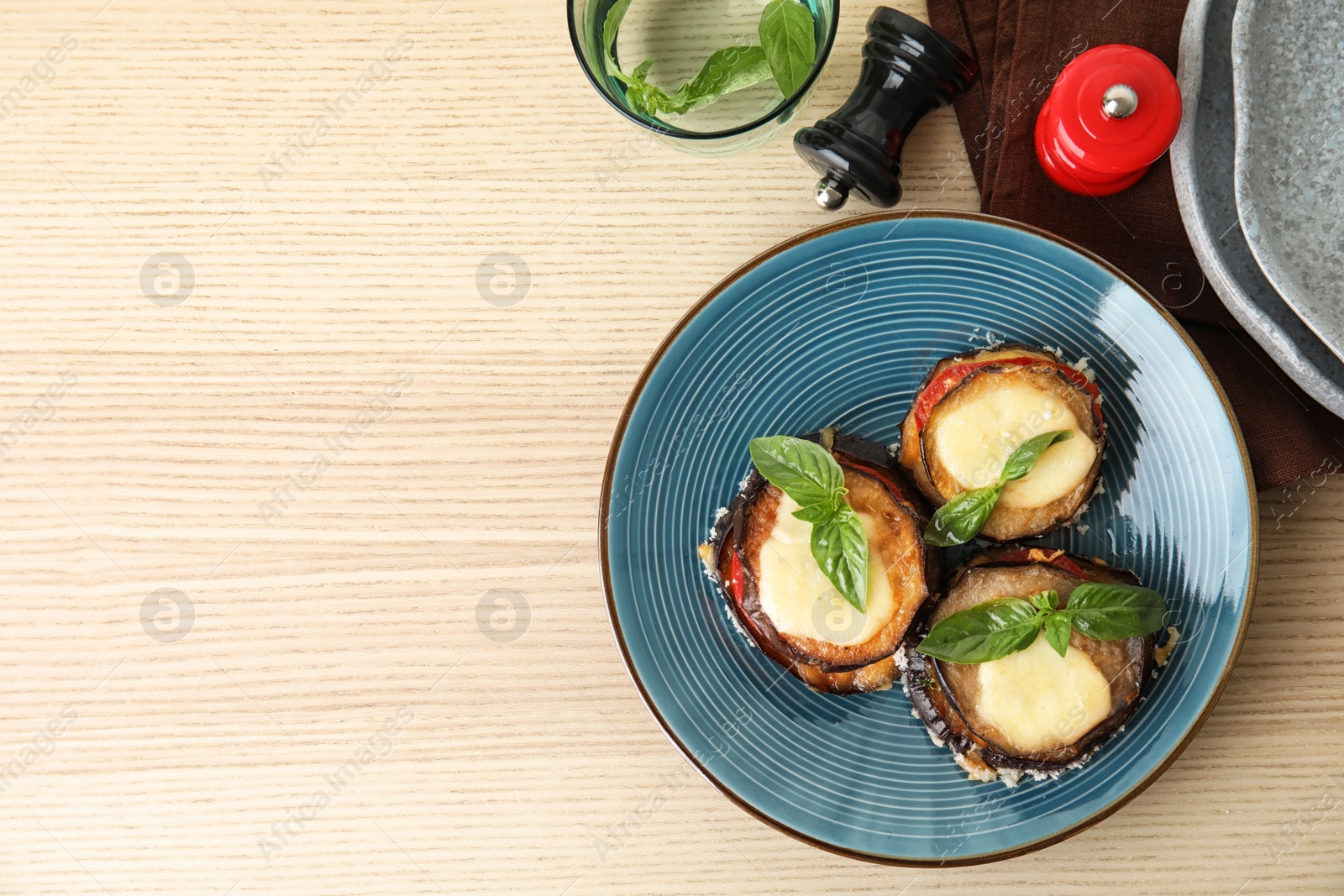 Photo of Flat lay composition with baked eggplant, tomatoes and cheese on wooden table. Space for text