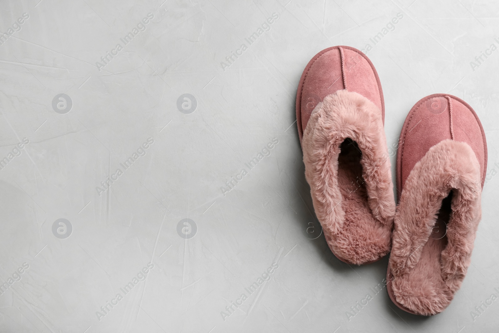Photo of Pair of soft slippers on light grey background, flat lay. Space for text