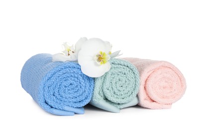 Clean soft towels with orchids isolated on white