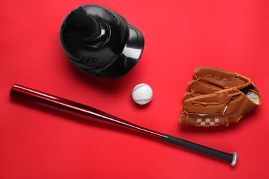 Baseball glove, bat, ball and batting helmet on red background, flat lay