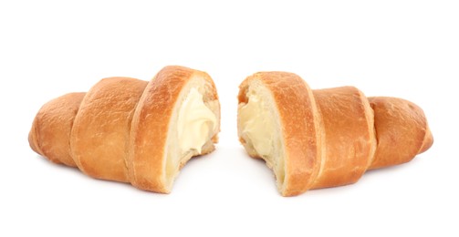 Photo of Halves of delicious croissant with cream on white background