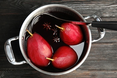 Image of Poaching pears in mulled wine on wooden table, top view