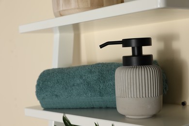 Shelving unit with toiletries near light wall indoors. Bathroom interior element