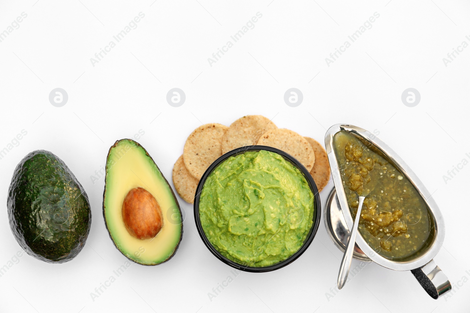 Photo of Delicious guacamole made of avocados and nachos on white background, top view