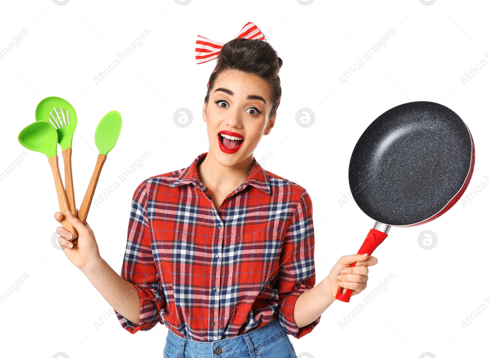 Photo of Funny young housewife with frying pan and cooking utensils on white background