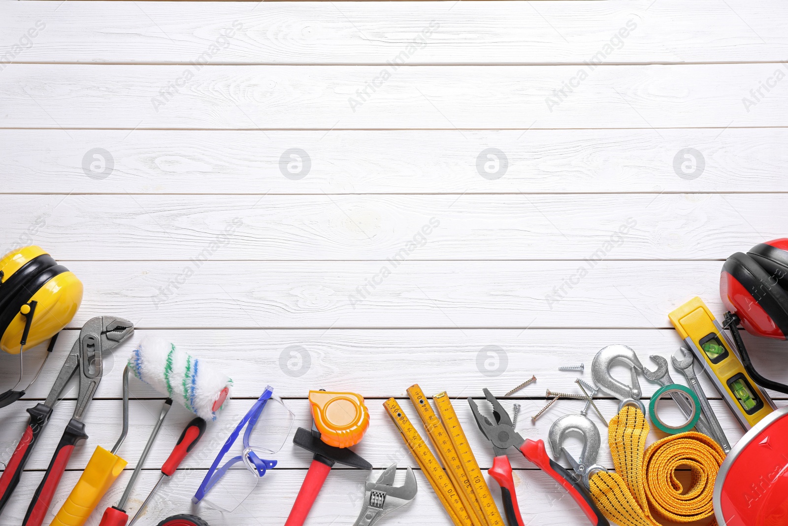 Photo of Flat lay composition with different construction tools and space for text on white wooden background