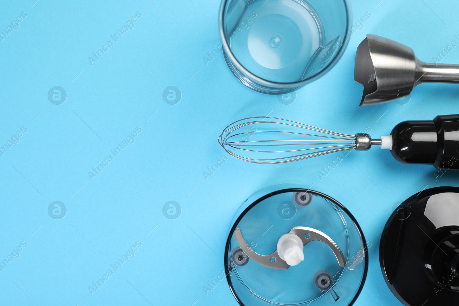 Photo of Hand blender kit on light blue background, flat lay. Space for text