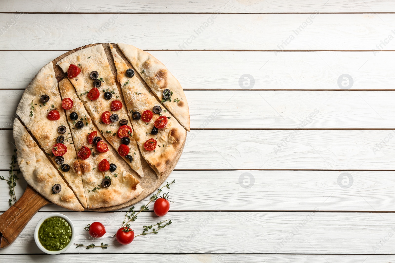 Photo of Flat lay composition with focaccia bread on white wooden table. Space for text