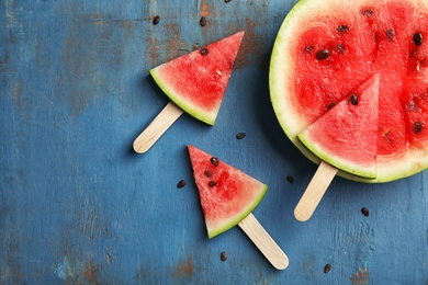 Photo of Flat lay composition with watermelon popsicles on wooden background