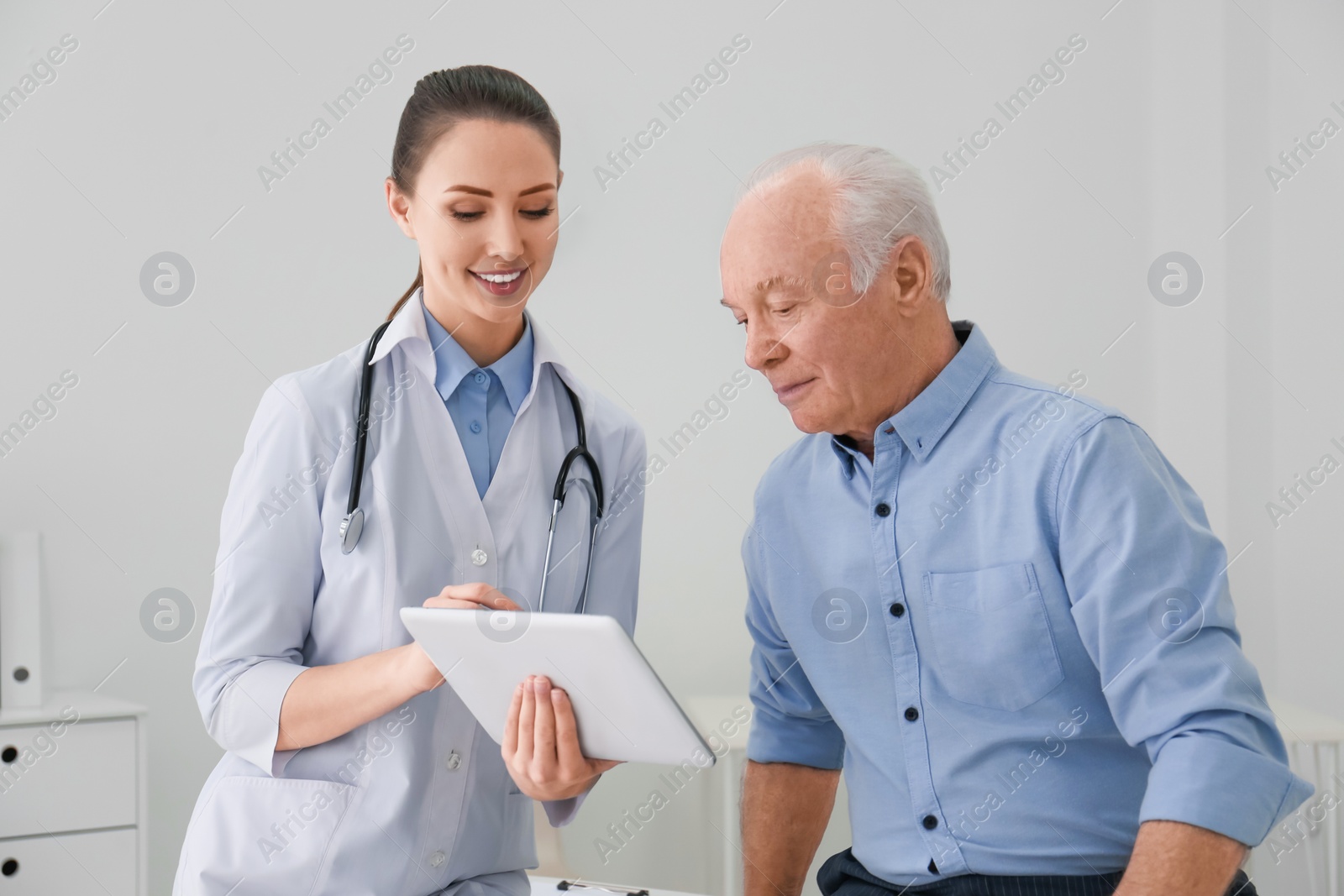 Photo of Senior man visiting doctor in modern office