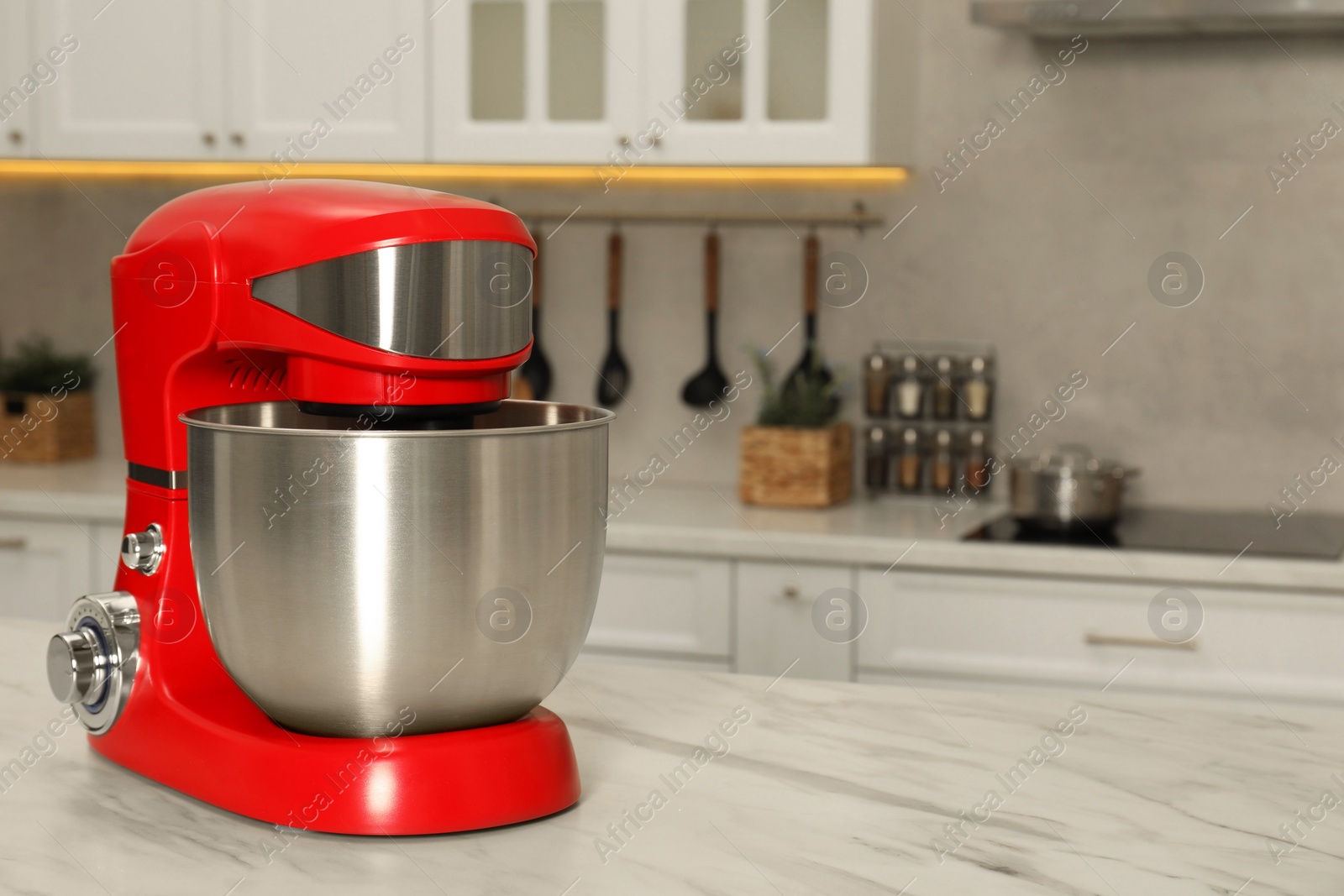 Photo of Modern red stand mixer on white marble table in kitchen, space for text