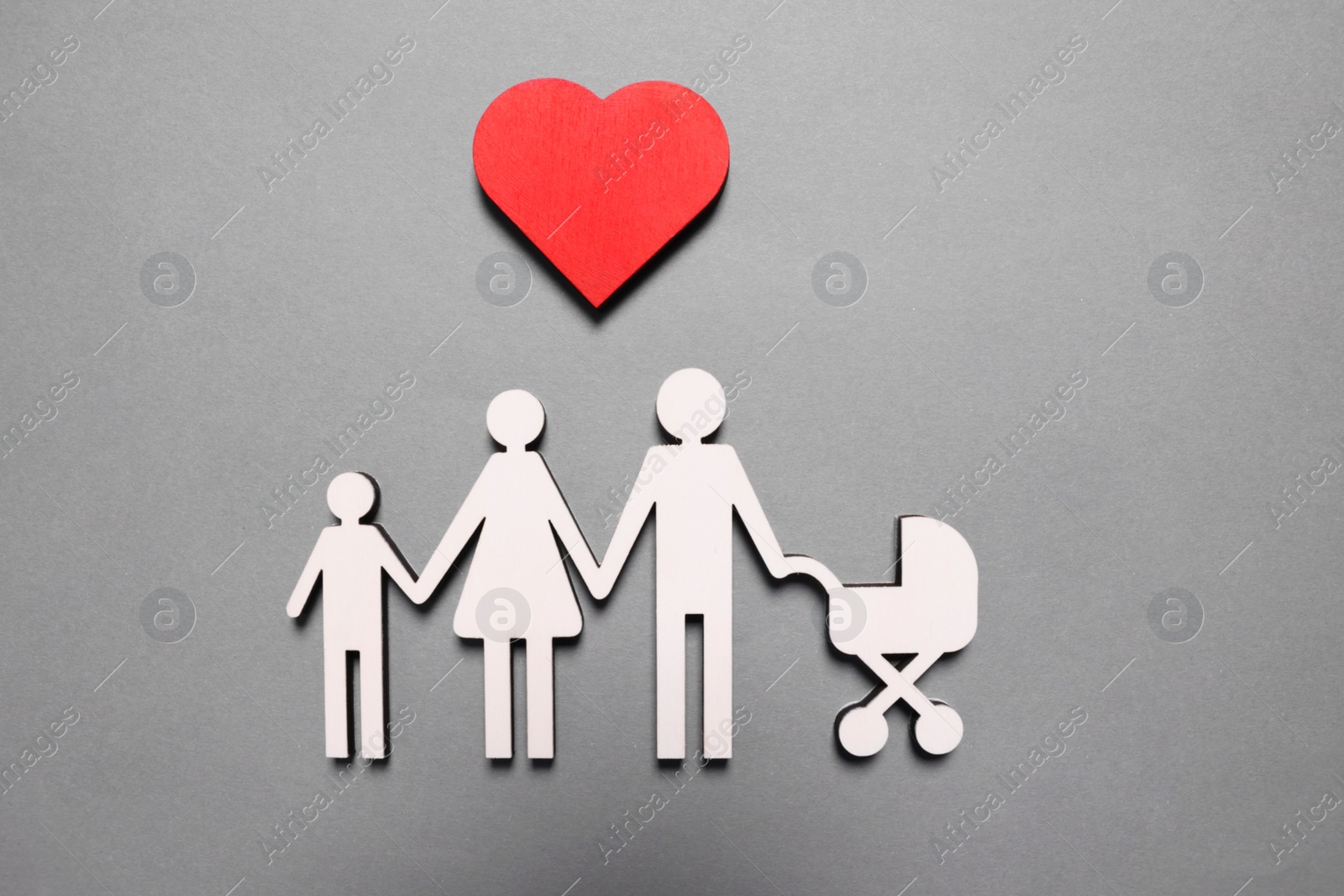 Photo of Figures of family under heart on lilac background, top view. Insurance concept