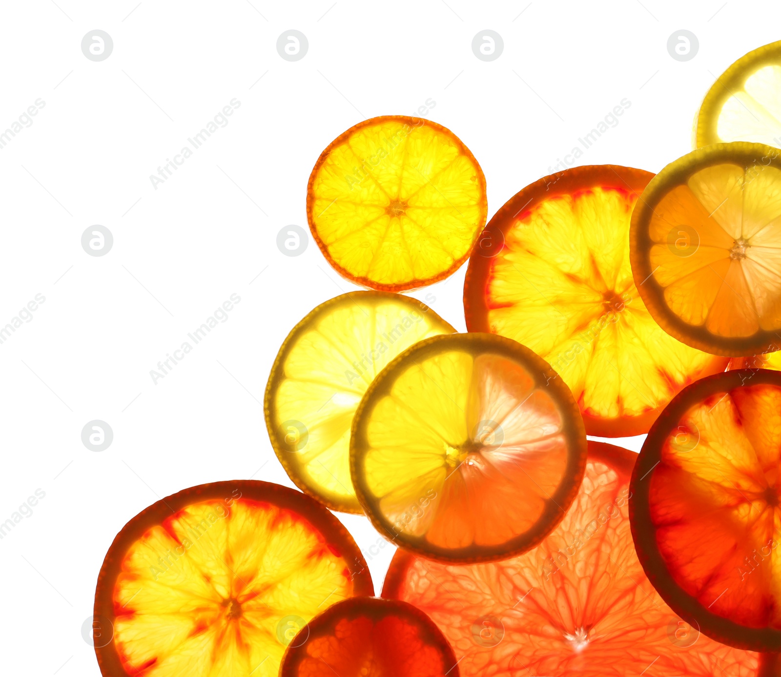 Photo of Illuminated slices of citrus fruits on white background, top view