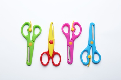 Photo of Set of training scissors on white background, top view