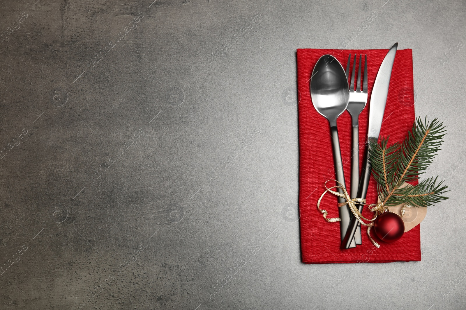 Photo of Cutlery and napkin on gray background, top view. Table setting