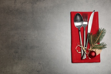 Photo of Cutlery and napkin on gray background, top view. Table setting