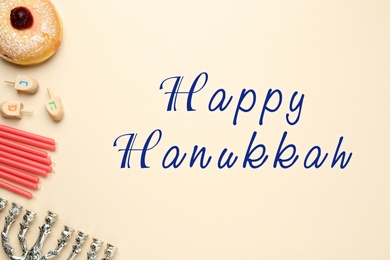 Image of Happy Hanukkah. Traditional menorah, candles, sufganiyah and dreidels on beige background, flat lay 