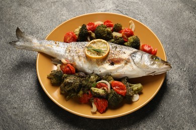 Photo of Delicious baked fish and vegetables on grey background, above view