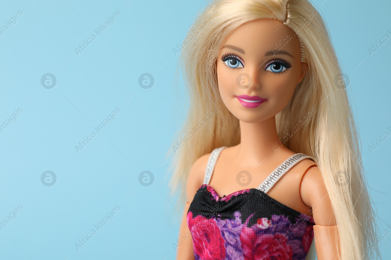 Photo of Mykolaiv, Ukraine - September 4, 2023: Beautiful Barbie doll on light blue background. Space for text