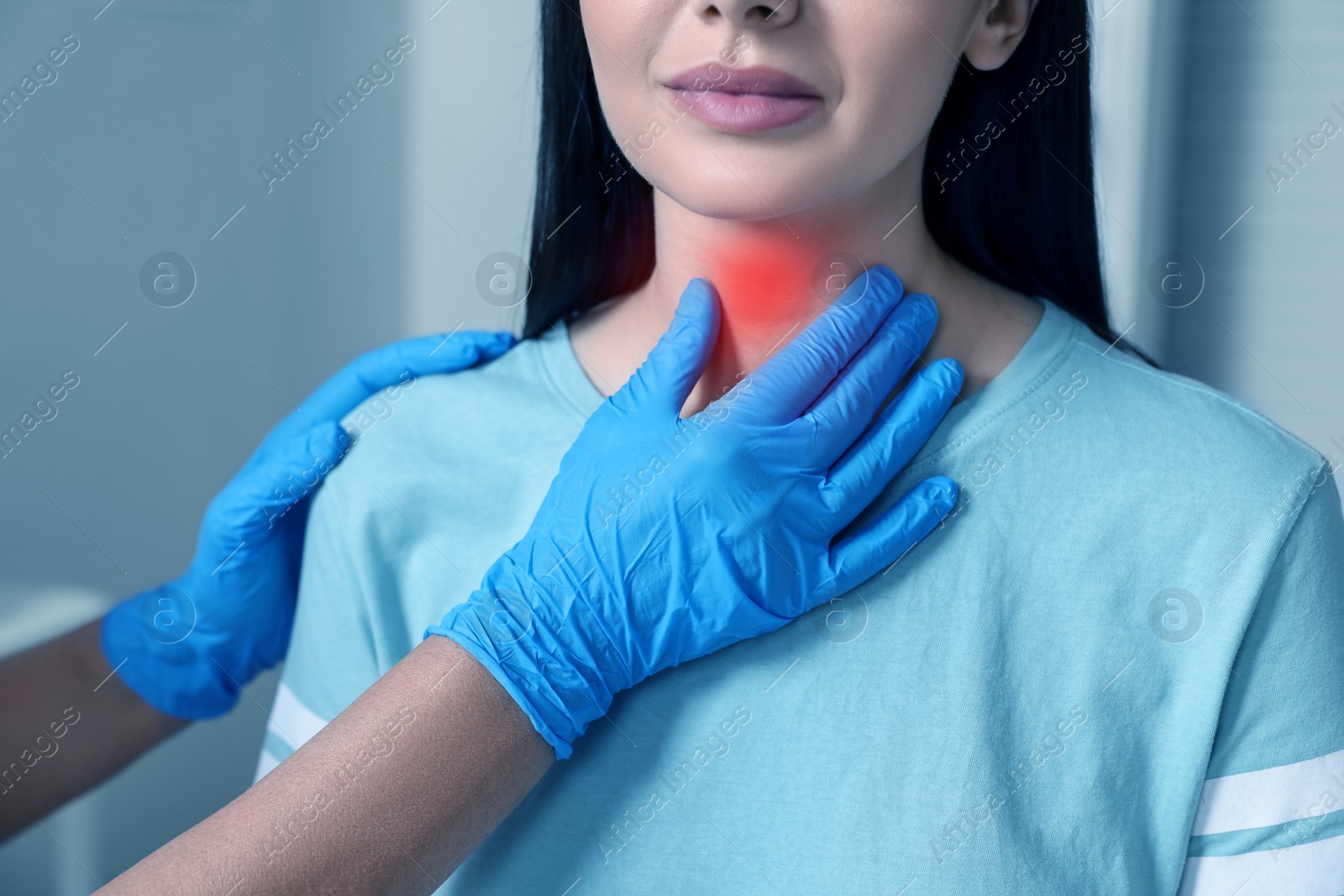 Image of Endocrinologist examining thyroid gland of patient at hospital, closeup