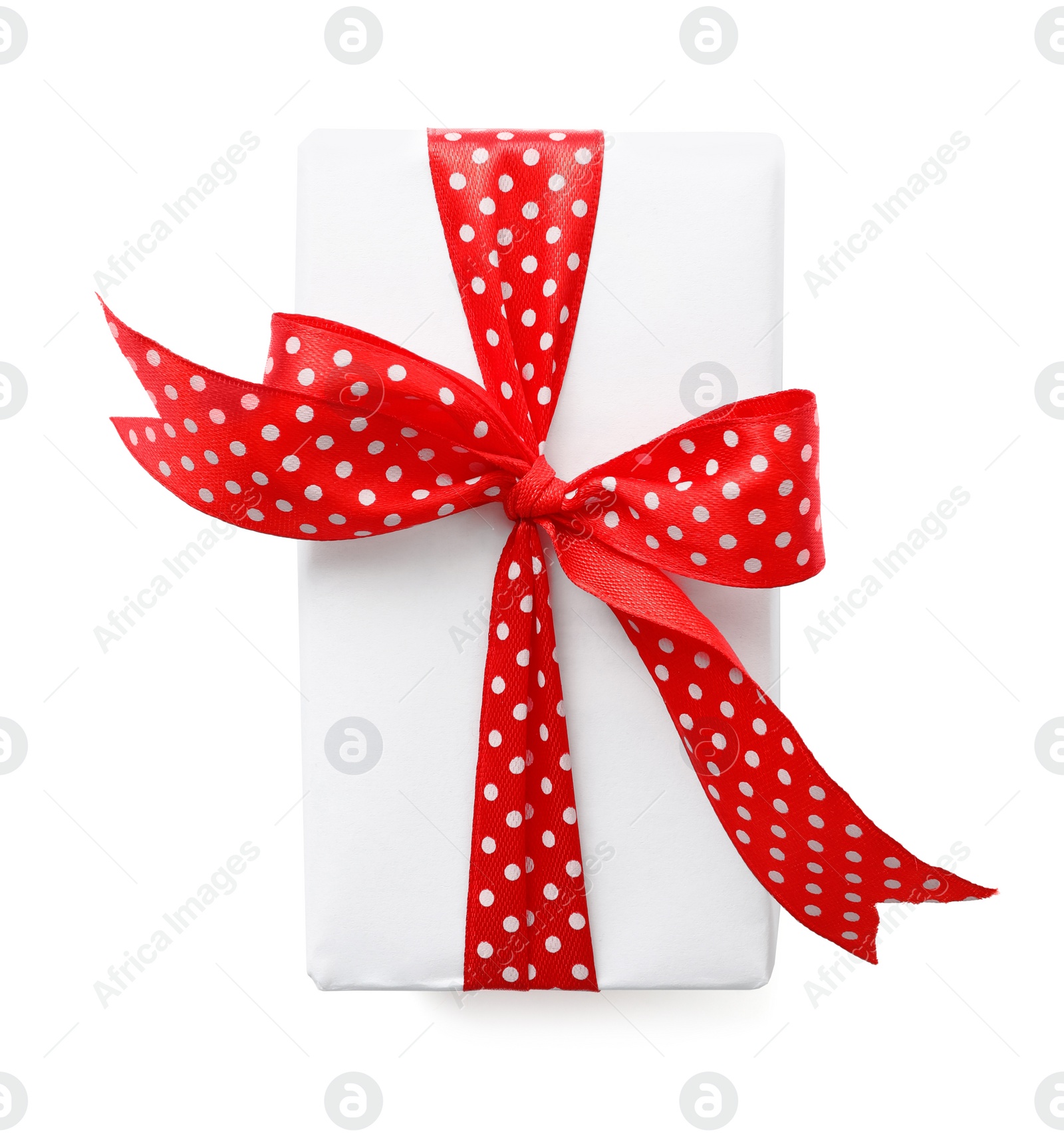 Photo of Christmas gift box decorated with red bow isolated on white, top view