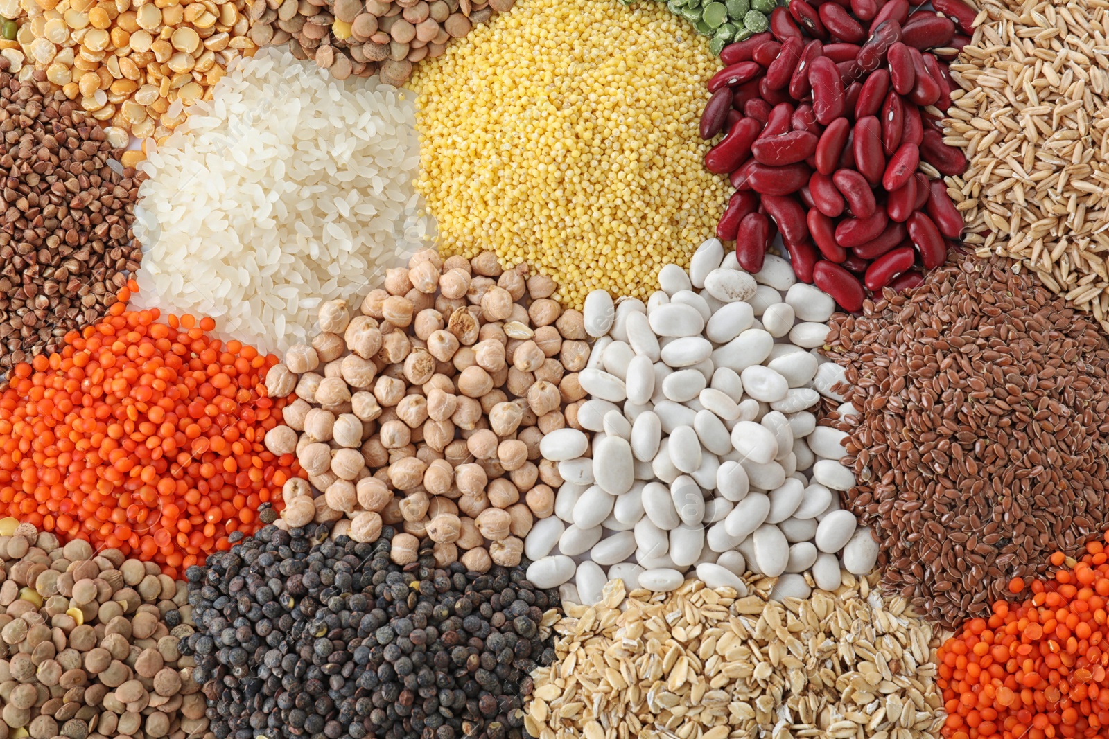 Photo of Different types of legumes and cereals as background, top view. Organic grains
