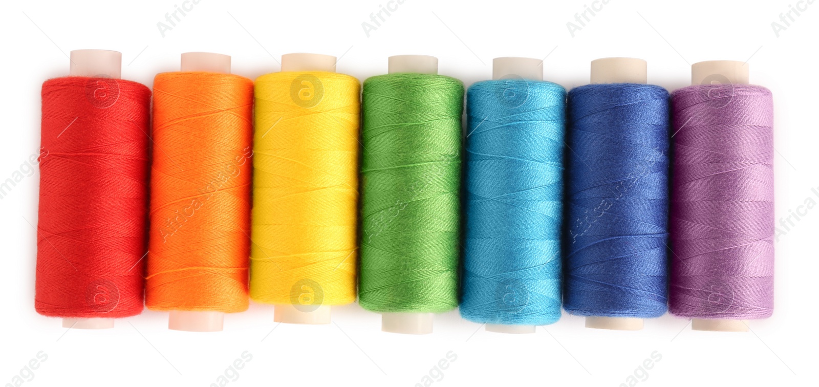 Photo of Set of colorful sewing threads on white background, top view