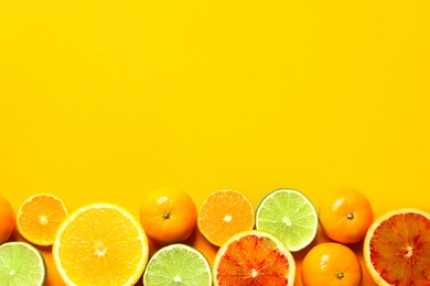 Photo of Different citrus fruits on color background, flat lay. Space for text