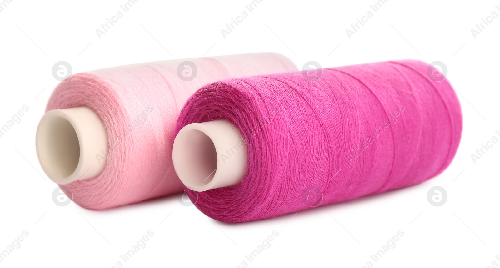 Photo of Different colorful sewing threads on white background, closeup