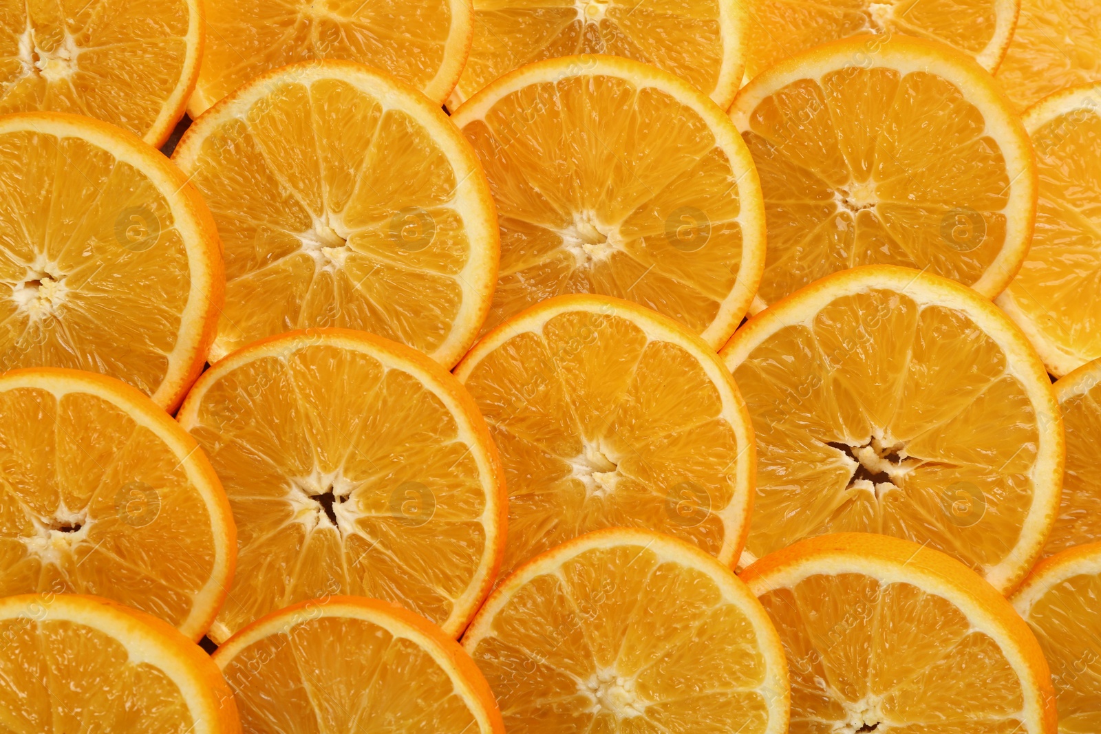 Photo of Slices of delicious oranges as background, closeup