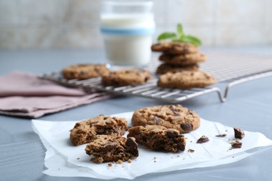 Photo of Tasty chocolate chip cookies on light grey table, closeup