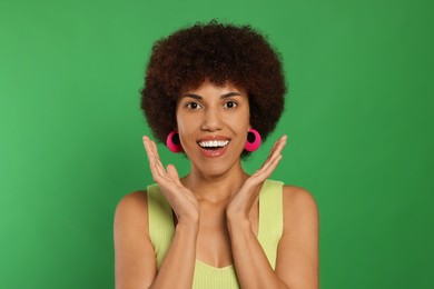 Photo of Portrait of emotional young woman on green background