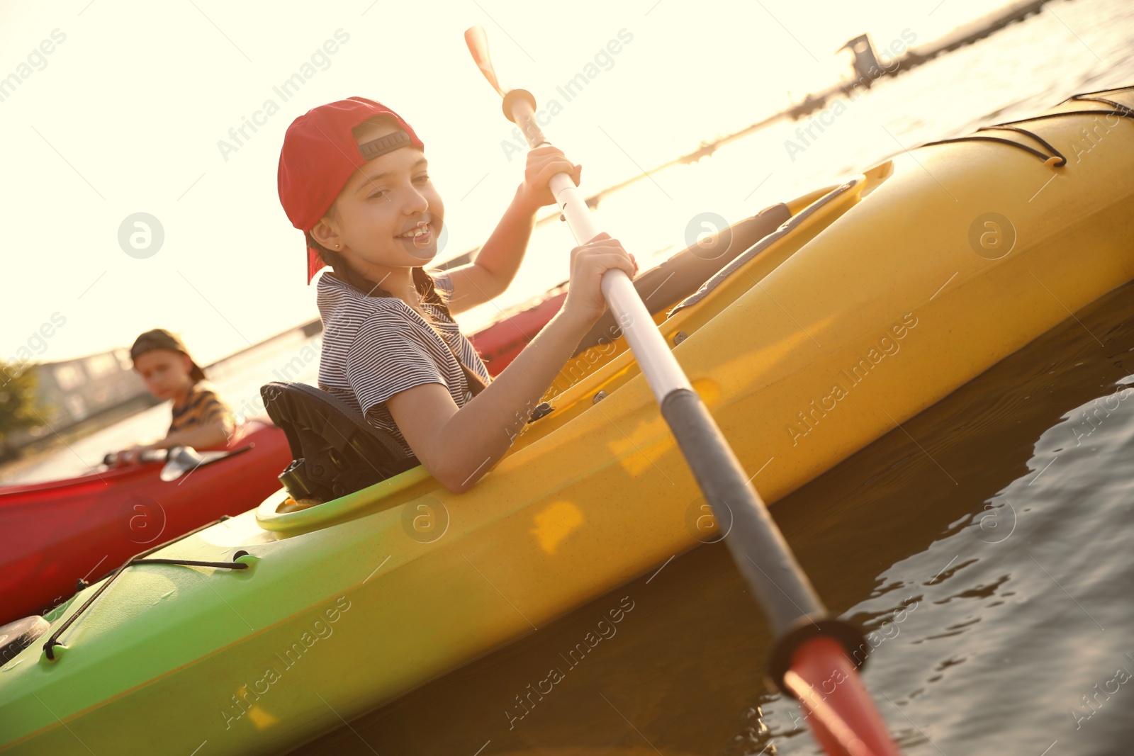 Photo of Little children kayaking on river. Summer camp activity