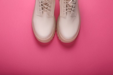 Photo of Pair of stylish leather shoes on pink background, flat lay. Space for text