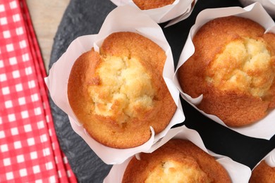 Delicious sweet muffins on table, top view